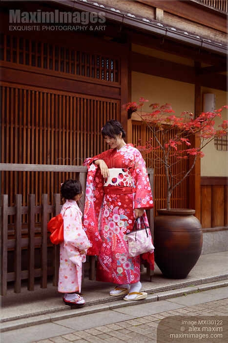 Stock photo of Japanese woman and her little daughter wearing red kimonos Gion Kyoto Japan Buy commercial use license at MaximImages