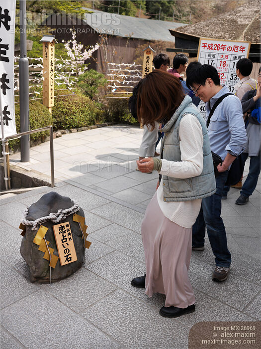 Stock photo of Japanese woman at Jishu Jinja shrine walking towards love rock at Kiyomizu-dera in Kyoto Buy commercial use license at MaximImages