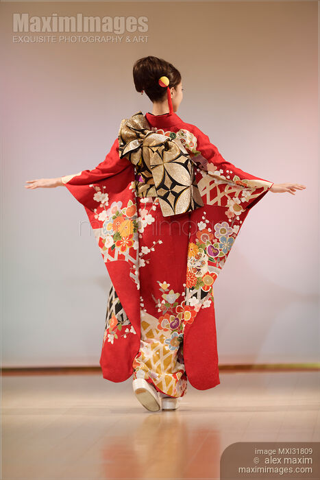 Japanese woman in a red kimono with long sleeves and an intricate gold obi belt bow on her back Stock photo of Japanese woman in a red kimono with long sleeves and an intricate gold obi belt bow on her back Buy commercial use license at MaximImages