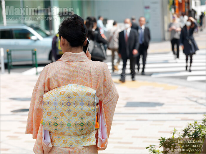 Stock photo of Japanese woman in kimono talking on cellphone Buy commercial use license at MaximImages