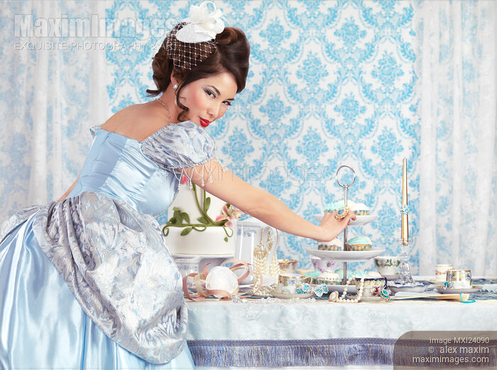 Lady taking a cupcake from a table Stock photo of Lady taking a cupcake from a table Buy commercial use license at MaximImages