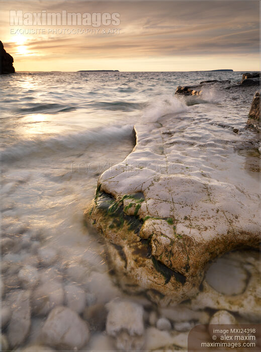 Stock photo of Landscape nature scenery of sunset over rocky shore Buy commercial use license at MaximImages