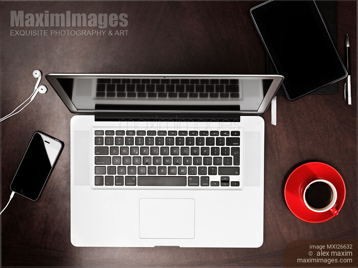 Stock photo of Laptop computer phone tablet and coffee on desk Buy commercial use license at MaximImages