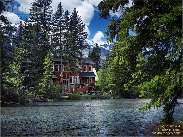 Stock photo of Large waterfront house in Canmore town Alberta springtime scenery Buy commercial use license at MaximImages
