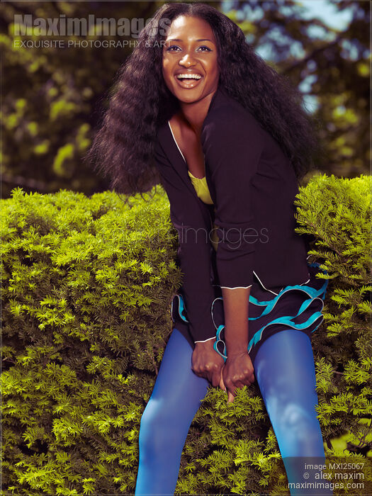 Laughing Young Black Woman in Park Stock photo of Laughing Young Black Woman in Park Buy commercial use license at MaximImages