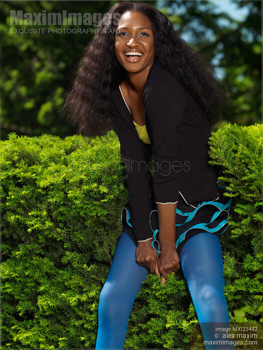 Stock photo of Laughing Young Woman in a Park Buy commercial use license at MaximImages