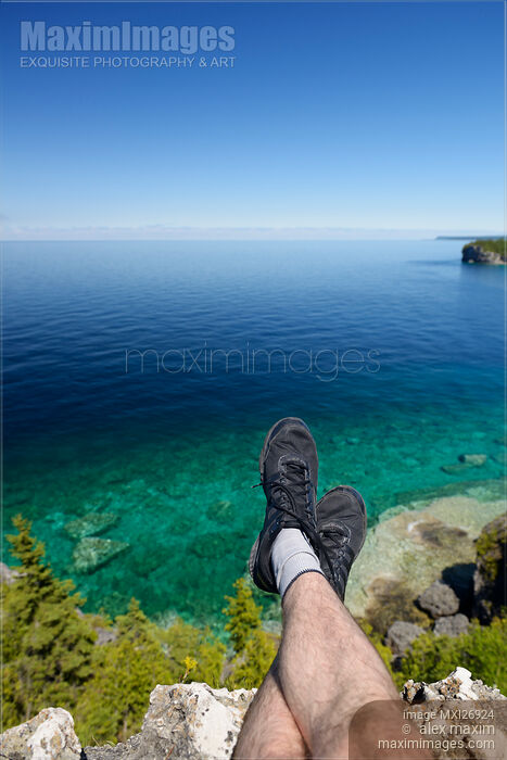 Legs of a person sitting on a cliff of Georgian Bay Bruce Peninsula in Canada Stock photo of Legs of a person sitting on a cliff of Georgian Bay Bruce Peninsula in Canada Buy commercial use license at MaximImages