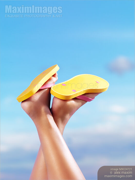 Legs of woman in yellow flip flops Stock photo of Legs of woman in yellow flip flops Buy commercial use license at MaximImages