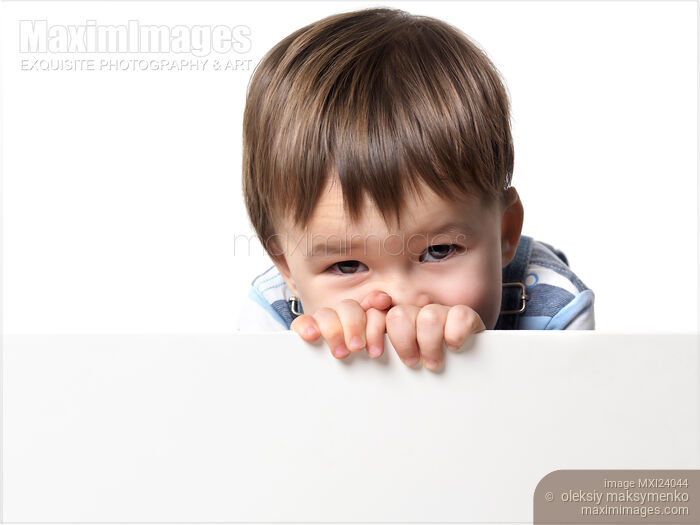 Stock photo of Little boy holding a white sign Buy commercial use license at MaximImages