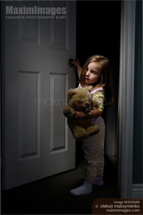 Stock photo of Little Girl Looking out of a Room at Night Buy commercial use license at MaximImages