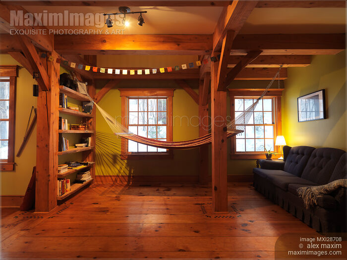 Stock photo of Lounge room with a hammock in timberframe Canadian house Buy commercial use license at MaximImages