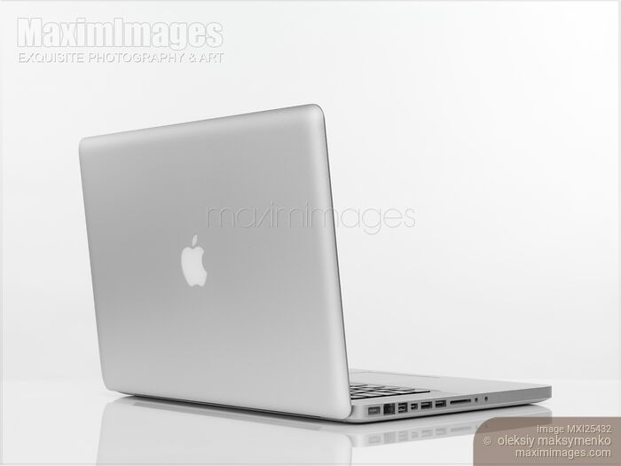 Stock photo of Macbook Pro laptop with Apple logo on the lid Buy commercial use license at MaximImages