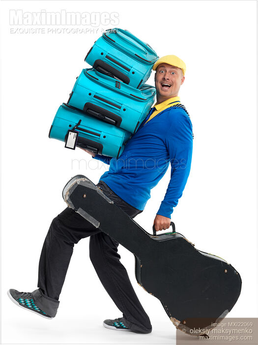 Man Carrying a Load of Luggage Stock photo of Man Carrying a Load of Luggage Buy commercial use license at MaximImages