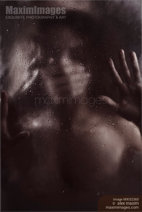 Stock photo of Man hand covering woman mouth silencing or suffocating her behind wet blurry glass in dark Buy commercial use license at MaximImages