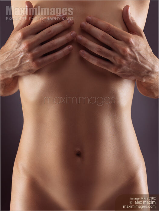 Stock photo of Man hands covering nude woman breasts Buy commercial use license at MaximImages