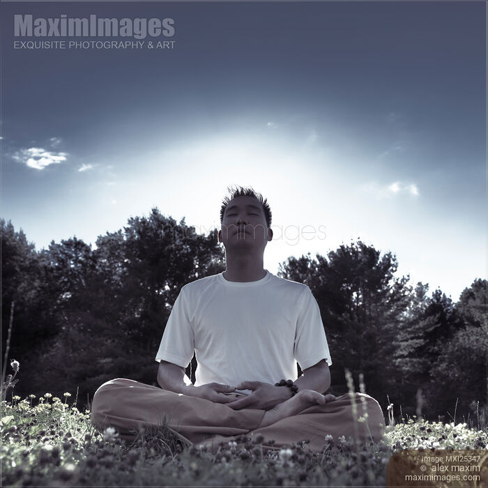 Stock photo of Man meditating in the nature during sunrise Buy commercial use license at MaximImages