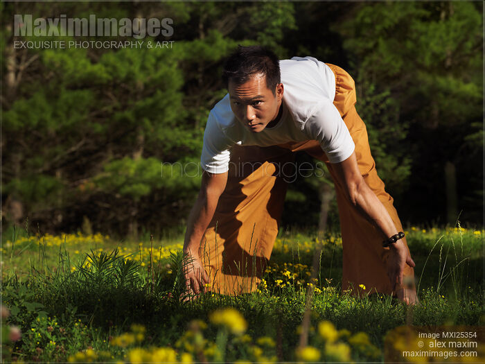 Stock photo of Man practicing Qi Gong outdoors Buy commercial use license at MaximImages