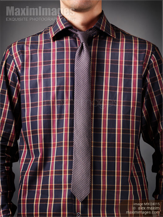 Stock photo of Man wearing a dark tartan shirt with a skinny necktie Buy commercial use license at MaximImages