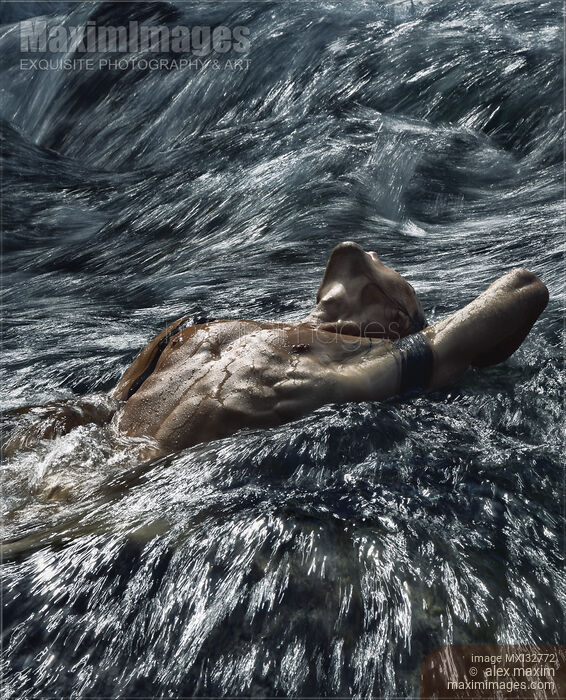 Man with naked wet body lying in rushing turbulent water of a river Dramatic moody photograph Stock photo of Man with naked wet body lying in rushing turbulent water of a river Dramatic moody photograph Buy commercial use license at MaximImages
