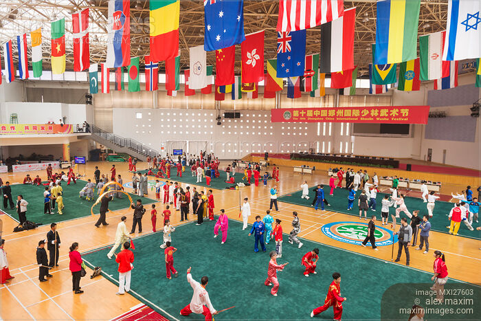 Stock photo of Martial artsts practicing on stage at Zhengzhou Shaolin Wushu festival Buy commercial use license at MaximImages