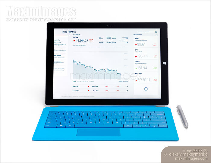 Stock photo of Microsoft Surface Pro 3 tablet with stock market charts on dispaly Buy commercial use license at MaximImages