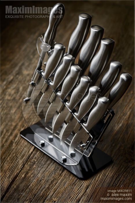 Stock photo of Modern steel kitchen knives set in knife block Buy commercial use license at MaximImages