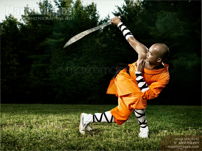Monk practicing Shaolin broad sword outdoors Stock photo of Monk practicing Shaolin broad sword outdoors Buy commercial use license at MaximImages
