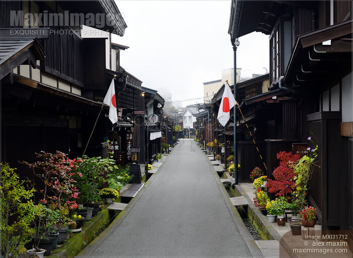 Stock photo of Morning scenery of Kamisannomachi old town street of Hida-Takayama with Japanese flags on Culture day Buy commercial use license at MaximImages