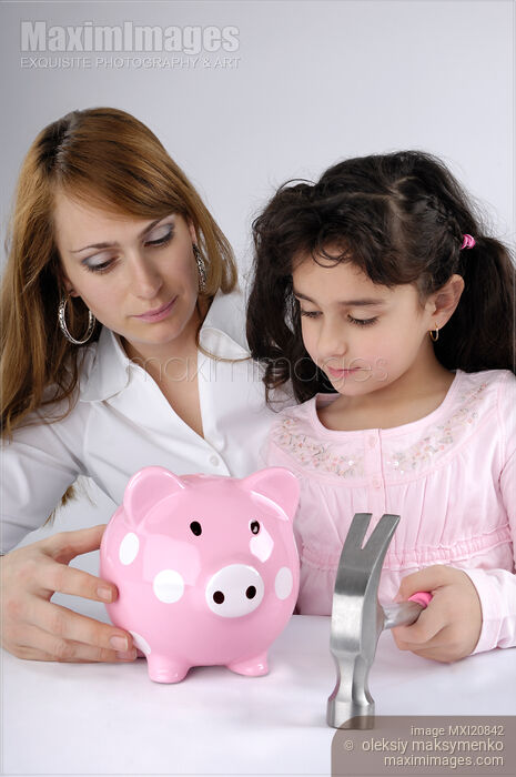 Stock photo of Mother and daughter about to break a piggy bank Buy commercial use license at MaximImages