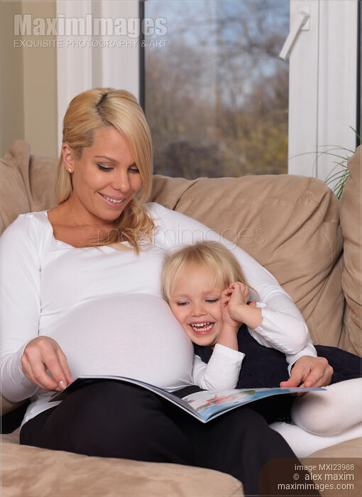 Mother and daughter reading a book together Stock photo of Mother and daughter reading a book together Buy commercial use license at MaximImages