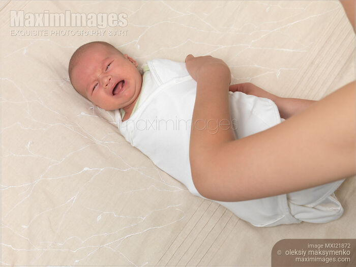 Stock photo of Mother Swaddling a Baby Buy commercial use license at MaximImages