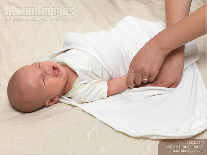 Stock photo of Mother Swaddling a Baby Buy commercial use license at MaximImages