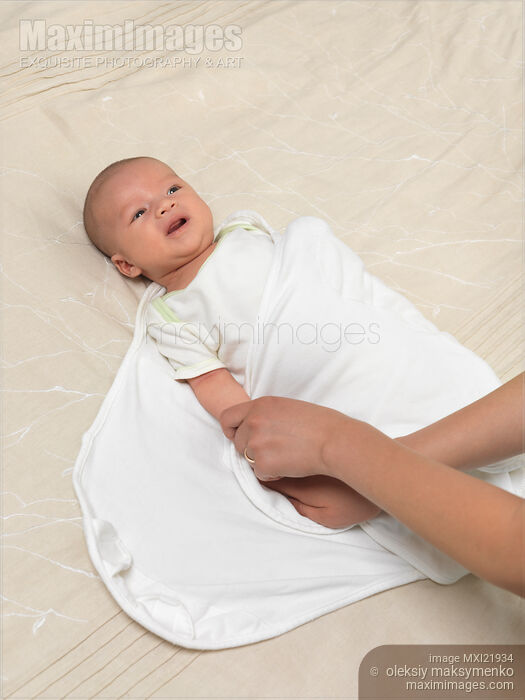 Photo of Mother Swaddling a Baby Stock Image MXI21934