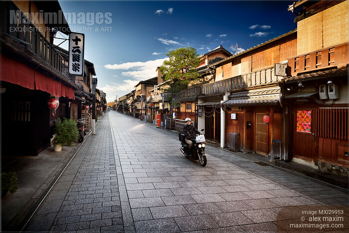 Motorcyclist on Hanamikoji Dori street in Gion district in the morning Kyoto Japan Stock photo of Motorcyclist on Hanamikoji Dori street in Gion district in the morning Kyoto Japan Buy commercial use license at MaximImages