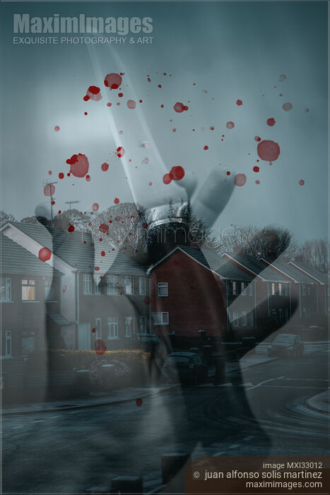 Stock photo of Murder and homicide concept of a hand with a knife and blood droplets in a city street view Buy commercial use license at MaximImages