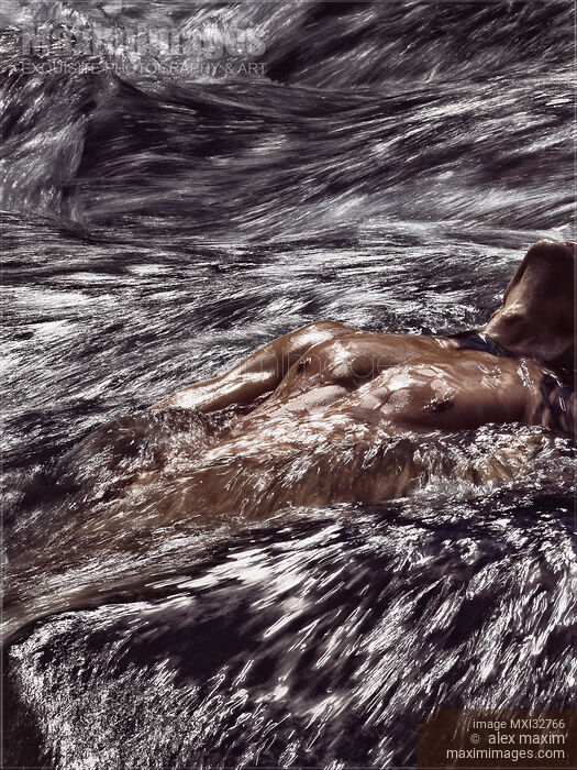 Stock photo of Muscular man half-naked body submerged in rushing river water or stormy sea waves Dramatic fine art portrait Buy commercial use license at MaximImages