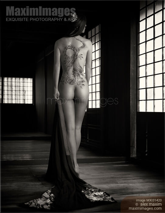 Mysterious asian woman standing naked in a dark house revealing a Yakuza fierce dragon tattoo on her nude back Stock photo of Mysterious asian woman standing naked in a dark house revealing a Yakuza fierce dragon tattoo on her nude back Buy commercial use license at MaximImages
