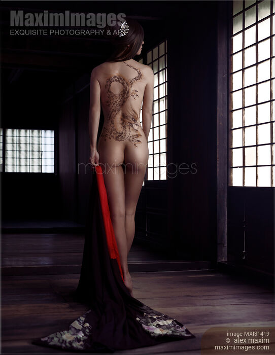 Mysterious Japanese lady with a dragon tattoo on her nude back standing undressed in a dark house Rear view Stock photo of Mysterious Japanese lady with a dragon tattoo on her nude back standing undressed in a dark house Rear view Buy commercial use license at MaximImages
