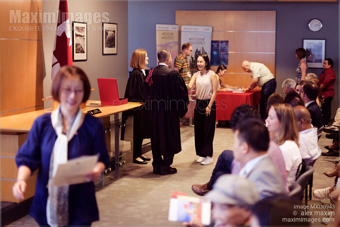 New Canadian citizens receiving their Citizenship certificates at a Citizenship ceremony in Canada Stock photo of New Canadian citizens receiving their Citizenship certificates at a Citizenship ceremony in Canada Buy commercial use license at MaximImages