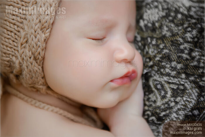 Stock photo of Newborn baby girl sleeping closeup of a cute face Buy commercial use license at MaximImages