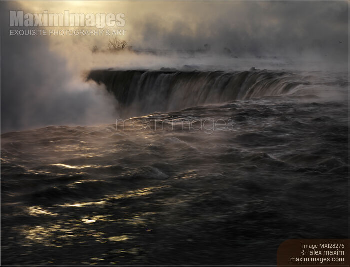 Stock photo of Niagara Falls covered in mist beautiful dramatic winter sunrise scenery Buy commercial use license at MaximImages