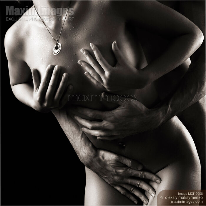 Stock photo of Nude Couple Making Love. Black and white closeup of their naked bodies. Buy commercial use license at MaximImages