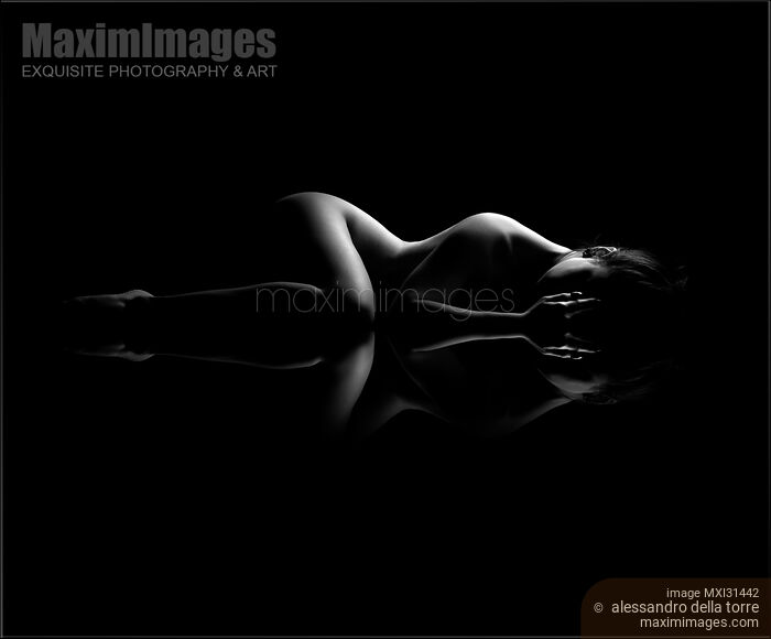 Nude woman body outline lying on black reflective background black and white Stock photo of Nude woman body outline lying on black reflective background black and white Buy commercial use license at MaximImages