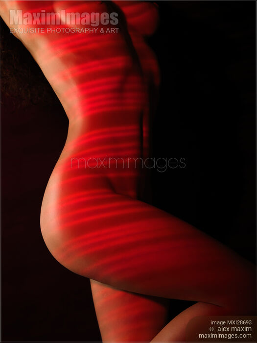 Nude woman body with red laser stripes skin rejuvenation concept Stock photo of Nude woman body with red laser stripes skin rejuvenation concept Buy commercial use license at MaximImages
