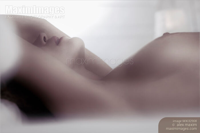Nude woman lying in bed Sensual closeup of her breasts nipples and her lips Stock photo of Nude woman lying in bed Sensual closeup of her breasts nipples and her lips Buy commercial use license at MaximImages