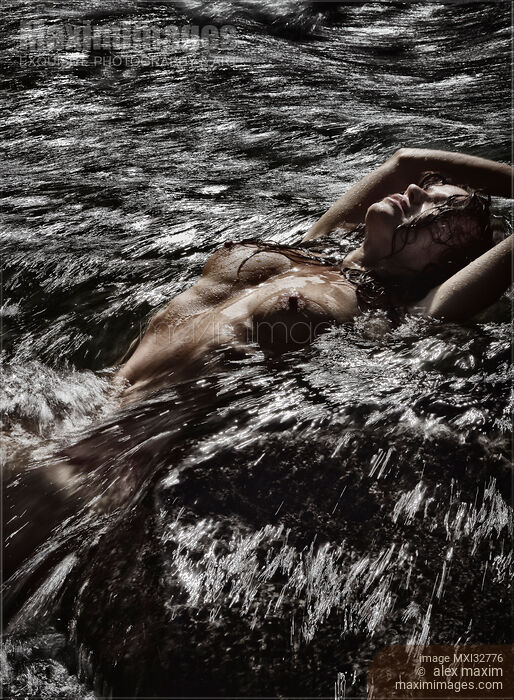 Nude woman lying in wild water of a rushing river her bare breasts and wet body arched above water Stock photo of Nude woman lying in wild water of a rushing river her bare breasts and wet body arched above water Buy commercial use license at MaximImages