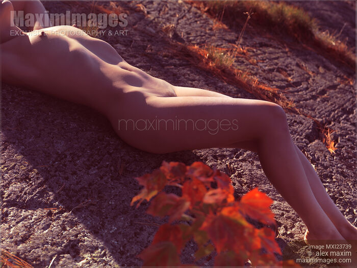 Stock photo of Nude Woman Lying on Rocks Buy commercial use license at MaximImages