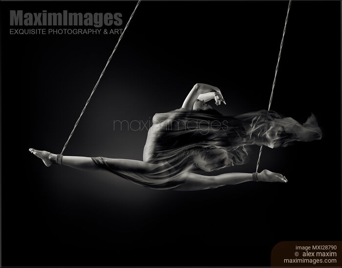 Nude woman swinging in splits in the air with bondage rope and flowing cloth around her naked body Stock photo of Nude woman swinging in splits in the air with bondage rope and flowing cloth around her naked body Buy commercial use license at MaximImages