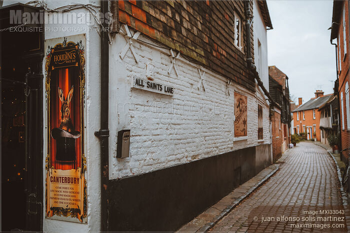 Stock photo of Old narrow cobbled street with houses and pubs in Canterbury England Buy commercial use license at MaximImages