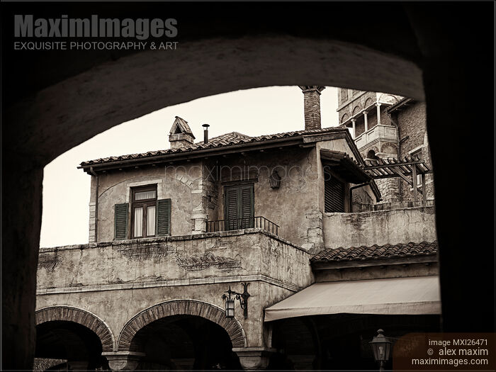 Stock photo of Old rustic house under an arch Buy commercial use license at MaximImages
